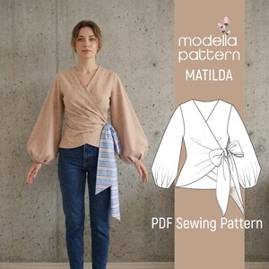 May include: A beige wrap top with long, voluminous sleeves and a blue and white striped tie. The top is paired with blue jeans. The image also includes a line drawing of the top and the text "modella pattern MATILDA" and "PDF Sewing Pattern."
