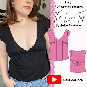 May include: A black short-sleeved top with a deep V-neckline and vertical pleats at the waist. The image includes text reading Easy PDF-sewing pattern The Lua Top By Eefje Patterns and SIZES XXS-XXL, alongside pink technical line drawings.