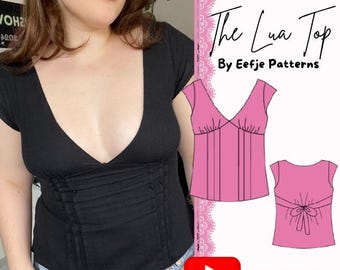 May include: A black short-sleeved top with a deep V-neckline and vertical pleats at the waist. The image includes text reading Easy PDF-sewing pattern The Lua Top By Eefje Patterns and SIZES XXS-XXL, alongside pink technical line drawings.