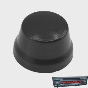 May include: A black, circular, tapered control knob with a smooth finish. In the bottom right corner, a car radio head unit is shown with a matching black knob installed on the left side, featuring a digital display with red text.