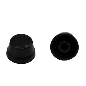 May include: Two black plastic knobs with a raised center and a small hole in the center. The knobs are used for adjusting the volume or other settings on a device.