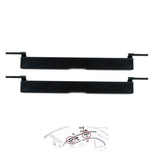 May include: Two identical black rectangular plastic automotive trim components, each featuring a central notch and thin protruding tabs on both ends. Below the parts, a small technical diagram shows the installation location on a vehicle roof.