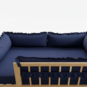 May include: A white ceramic mug with a black handle and the text "But First, Coffee" in a black, bold font. The mug is on a white surface.