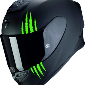 Könnte beinhalten: Ein schwarzer Motorradhelm mit grünen klauenartigen Grafiken an der Seite.