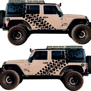 May include: A tan Jeep Wrangler with black tire tread decals on the side. The Jeep has a black roof rack and black wheels.