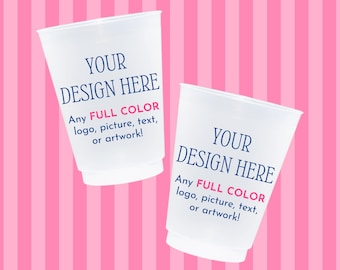 May include: Two white plastic cups with the text "YOUR DESIGN HERE" in blue and "Any FULL COLOR logo, picture, text, or artwork!" in red. The background is a pink and white striped pattern.