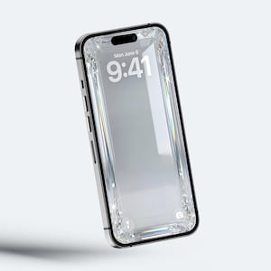 May include: A silver smartphone with a black border and a clear, diamond-encrusted screen. The screen displays the date, Monday, June 6, and the time, 9:41. The phone is set against a white background.