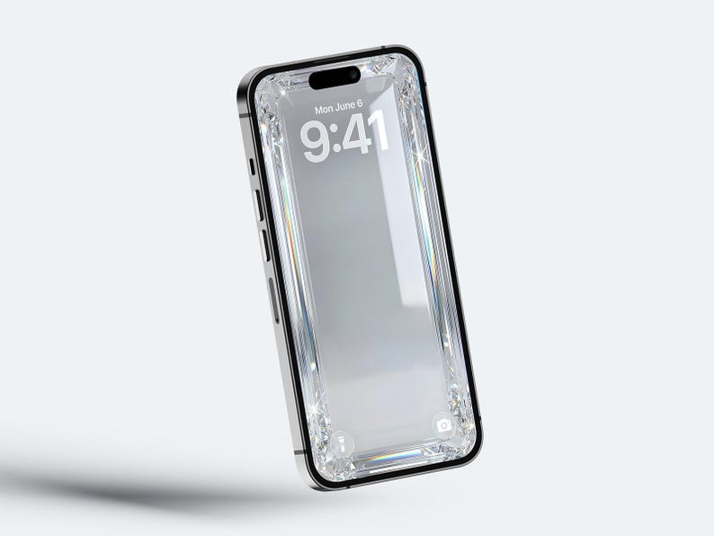May include: A silver smartphone with a black border and a clear, diamond-encrusted screen. The screen displays the date, Monday, June 6, and the time, 9:41. The phone is set against a white background.