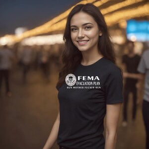 A woman with long brown hair wearing a black t-shirt printed with white FEMA evacuation plan text.