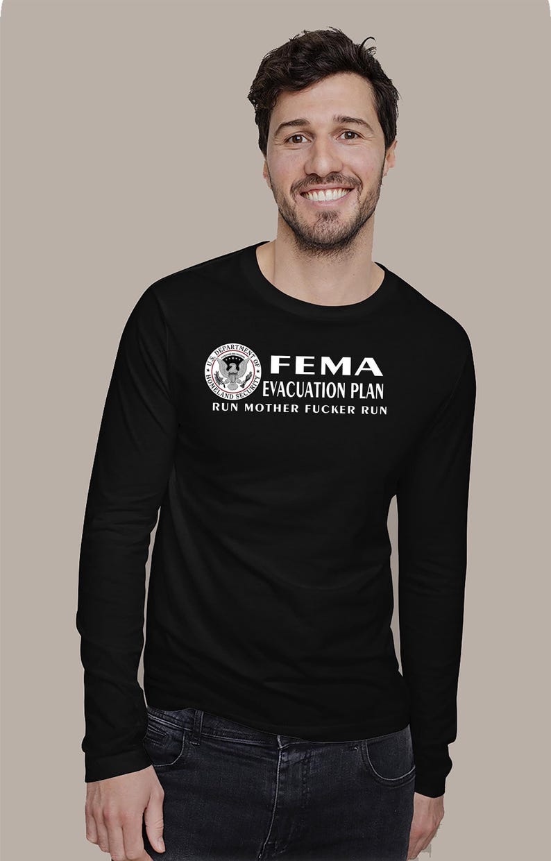 A man wearing a black long-sleeve shirt with the white FEMA evacuation plan design against a plain background.