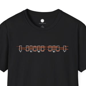 May include: Black t-shirt with a minimalist graphic design in orange and white. The design features a series of rectangular shapes and lines. The shirt is made of a soft material and has a classic crew neck.