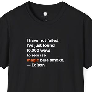 May include: Black t-shirt with the quote "I have not failed. I've just found 10,000 ways to release magic blue smoke. - Edison" printed in white. The text is centered on the front of the shirt.