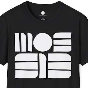 May include: Black crew neck t-shirt with a white geometric design on the front. The design features a circle, horizontal lines, and vertical lines. The shirt is made of a soft material.