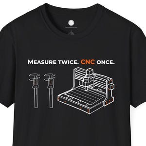 May include: Black t-shirt featuring the text "MEASURE TWICE. CNC ONCE." and a white graphic of a CNC machine and calipers with orange accents. The shirt has a crew neck and short sleeves.