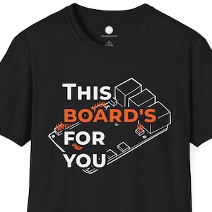 May include: Black t-shirt with the text "THIS BOARD'S FOR YOU" in white and orange. The graphic is a stylized circuit board design. The shirt is a short-sleeved crew neck.