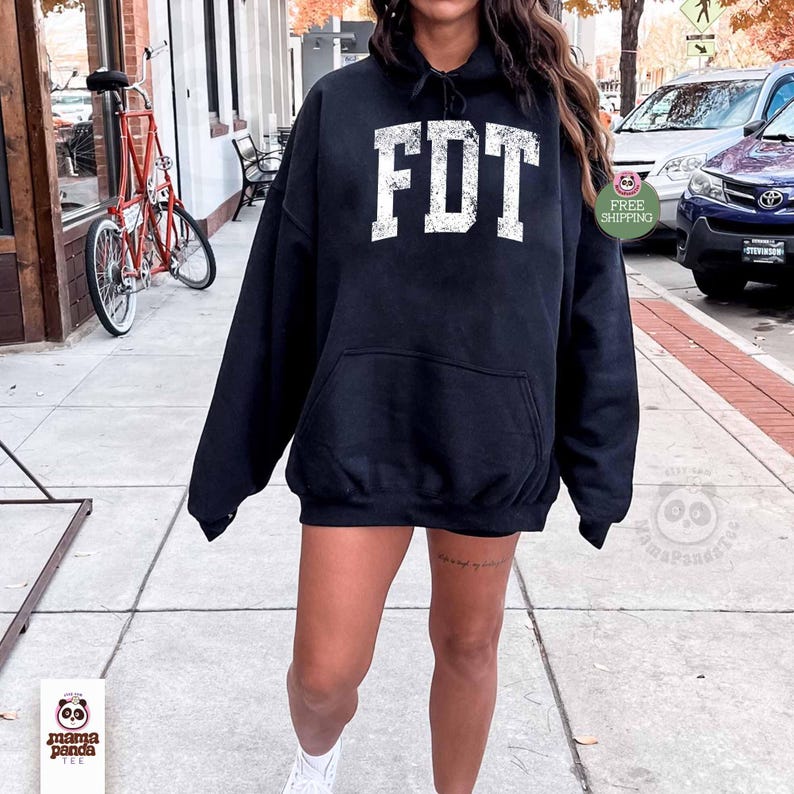 May include: A black hoodie with a white distressed graphic that says "FDT" on the front. The hoodie has a drawstring hood and a kangaroo pocket.