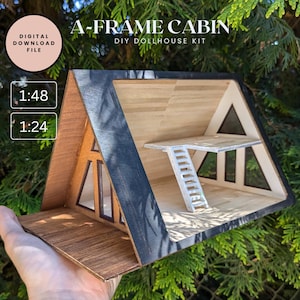 May include: A-Frame Cabin DIY Dollhouse Kit, a wooden model of a cabin with a black and white interior, windows, and a ladder. The kit is available in 1:48 and 1:24 scale.