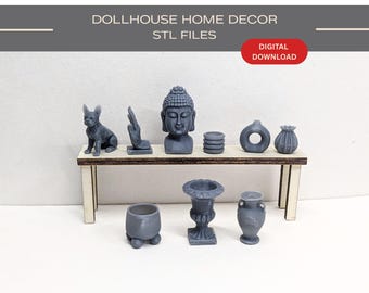 May include: A collection of miniature gray 3D printed dollhouse home decor items including a dog figurine, a Buddha head, vases, and planters displayed on a small wooden table. The text DOLLHOUSE HOME DECOR STL FILES and DIGITAL DOWNLOAD is visible.