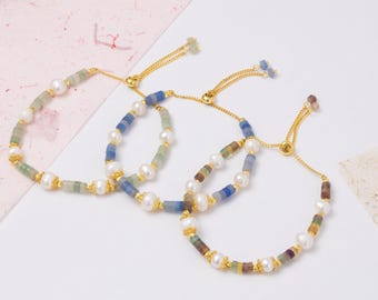 May include: Three adjustable bracelets with gold chains and clasps. Each bracelet features a combination of white pearls and colorful, small, square-cut gemstones. The bracelets are displayed on a white surface with a pink and beige background.