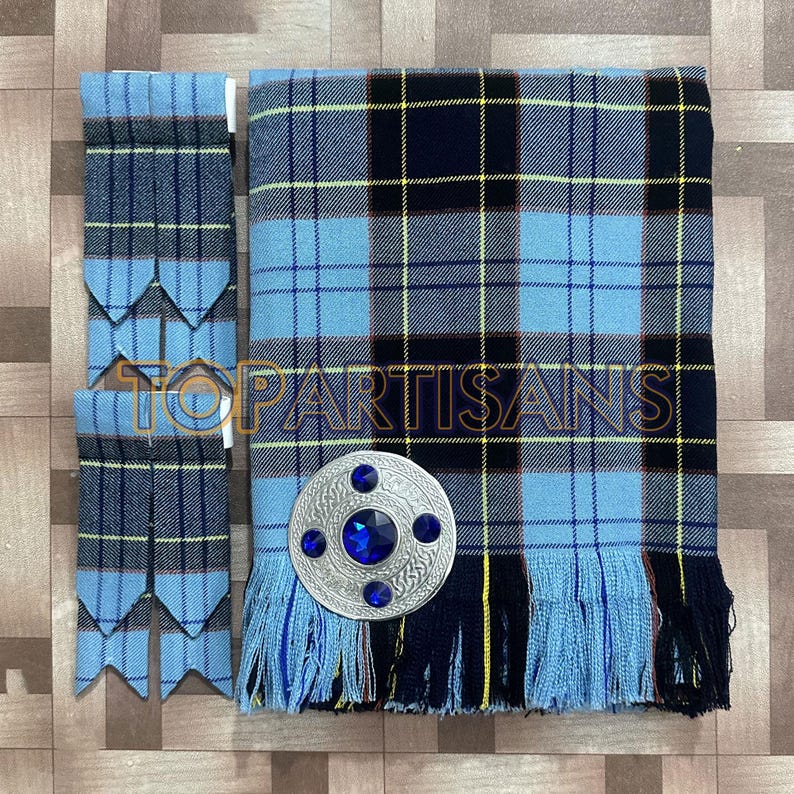 May include: A blue and black plaid kilt with matching accessories. The kilt features a silver brooch with blue gemstones. The accessories include a pair of garter flashes. The image has the text "TOP ARTISANS".