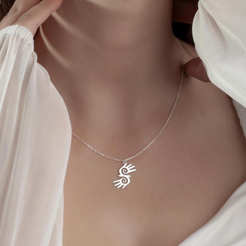Healing Hands Necklace. Crafted from sterling silver, this Hopi hands pendant symbolizes peace, balance, and the power of touch. Featuring two healing hands, this Reiki pendant is a meaningful gift for healers, medical professionals, and spiritual seekers. Whether you’re drawn to its symbolic energy or its artistic beauty, this peaceful charm makes a stunning medical jewelry piece for everyday wear.