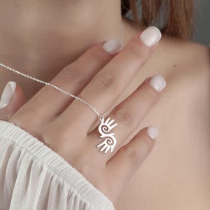 Healing Hands Necklace. Crafted from sterling silver, this Hopi hands pendant symbolizes peace, balance, and the power of touch. Featuring two healing hands, this Reiki pendant is a meaningful gift for healers, medical professionals, and spiritual seekers. Whether you’re drawn to its symbolic energy or its artistic beauty, this peaceful charm makes a stunning medical jewelry piece for everyday wear.