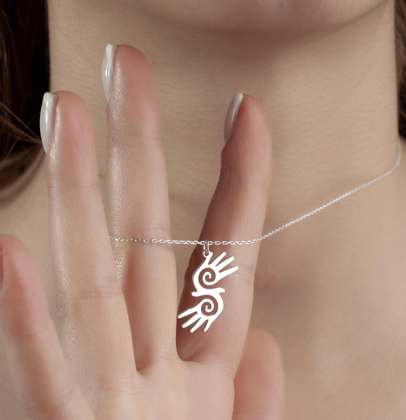 Healing Hands Necklace. Crafted from sterling silver, this Hopi hands pendant symbolizes peace, balance, and the power of touch. Featuring two healing hands, this Reiki pendant is a meaningful gift for healers, medical professionals, and spiritual seekers. Whether you’re drawn to its symbolic energy or its artistic beauty, this peaceful charm makes a stunning medical jewelry piece for everyday wear.
