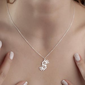 Healing Hands Necklace. Crafted from sterling silver, this Hopi hands pendant symbolizes peace, balance, and the power of touch. Featuring two healing hands, this Reiki pendant is a meaningful gift for healers, medical professionals, and spiritual seekers. Whether you’re drawn to its symbolic energy or its artistic beauty, this peaceful charm makes a stunning medical jewelry piece for everyday wear.