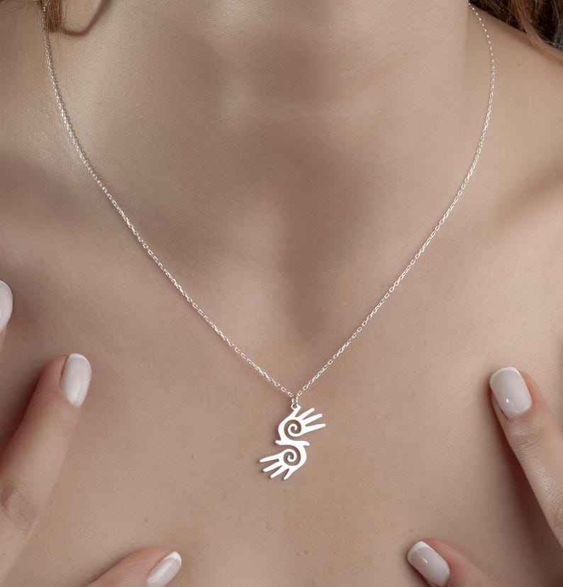 Healing Hands Necklace. Crafted from sterling silver, this Hopi hands pendant symbolizes peace, balance, and the power of touch. Featuring two healing hands, this Reiki pendant is a meaningful gift for healers, medical professionals, and spiritual seekers. Whether you’re drawn to its symbolic energy or its artistic beauty, this peaceful charm makes a stunning medical jewelry piece for everyday wear.