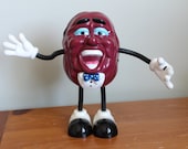 California Raisin AM FM Radio Battery Included, Works Great, Missing a Microphone in Hand, 7.5 Inches Tall, Bendable Arms and Legs