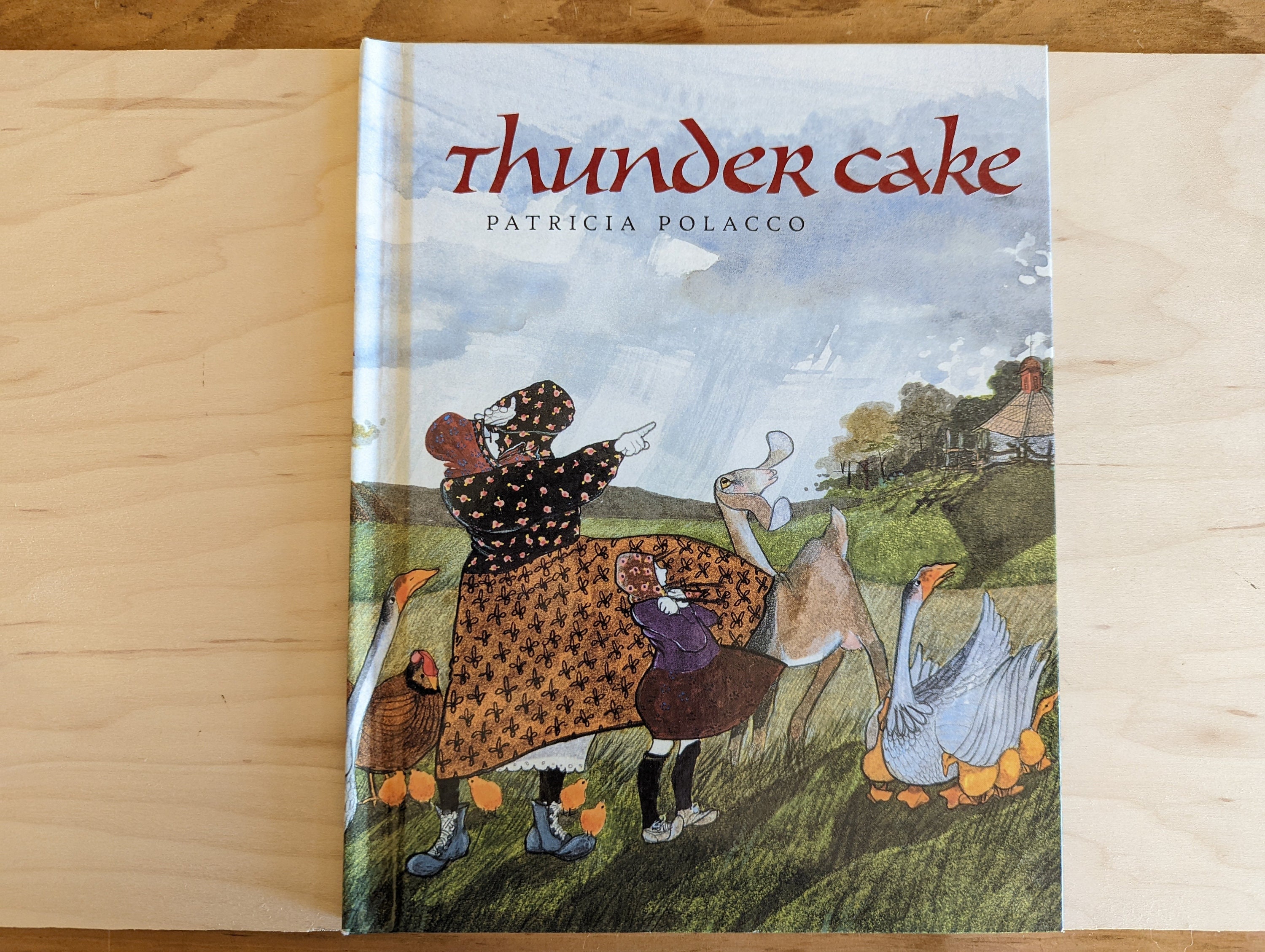 THUNDER CAKE (DJ protected by a brand new, clear, acid-free mylar cover)  (Signed by Author) by Patricia Polacco - Signed First Edition - 1990 - from  Sage Rare & Collectible Books, IOBA (SKU: 3203)