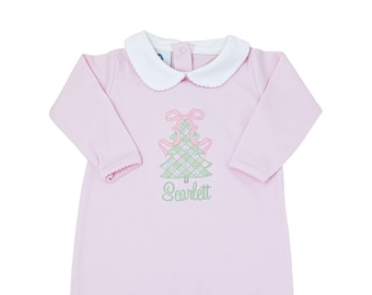May include: A light pink long-sleeve baby gown featuring a white Peter Pan collar and a central embroidered design of a green plaid Christmas tree topped with a pink bow. The name Scarlett is embroidered in green cursive script below the tree.