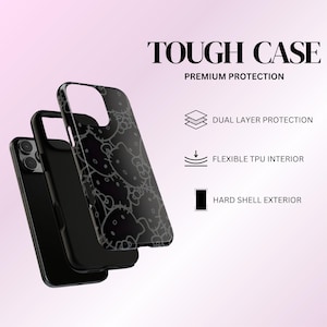 May include: Black phone case with a Hello Kitty pattern. The case is labeled "TOUGH CASE" and "PREMIUM PROTECTION". Features include dual-layer protection, a flexible TPU interior, and a hard shell exterior.
