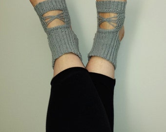 May include: A pair of gray knitted ankle socks with a criss-cross design at the ankle.