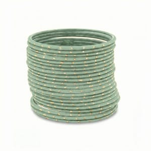 May include: A collection of sage green bangles with gold dot detailing. The bangles are stacked, creating a layered effect. The jewellery is set against a white background.