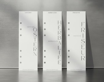 May include: Three white rectangular planner inserts with six punched holes along the left side. Each insert features black text printed vertically and horizontally. The text reads Ostern, Herbalife, and Friseur, with the brand name Budgetbybailey at the bottom.
