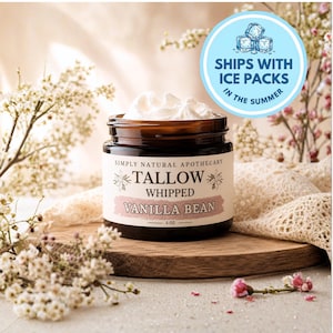 May include: A brown glass jar filled with white whipped tallow, topped with a cream-colored label reading Simply Natural Apothecary Tallow Whipped Vanilla Bean 2 oz. The jar sits on a wooden base surrounded by small white flowers and lace fabric.