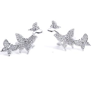 May include: A pair of silver butterfly earrings with clear crystal accents. The earrings feature three butterflies each, with the largest butterfly in the center and two smaller butterflies on either side.