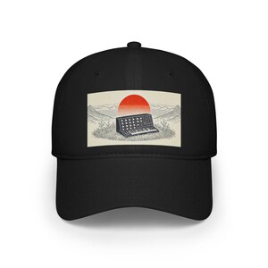 May include: Black baseball cap with a white and red illustration of a synthesizer in a landscape with a red sun. The text "Synth Sunset" is printed on the cap.
