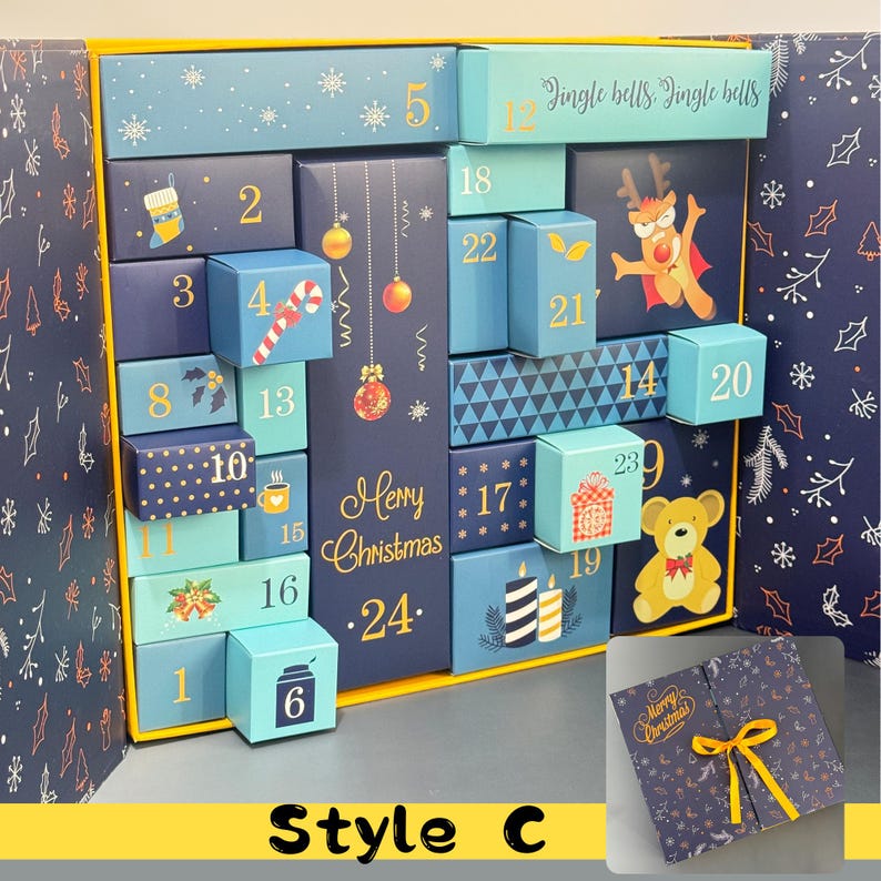 May include: A blue and gold Christmas advent calendar with 24 numbered boxes. The boxes are decorated with festive images like a reindeer, ornaments, and a teddy bear. The words "Merry Christmas" are displayed on the front.