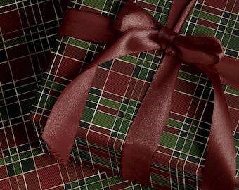 May include: A wrapped gift box with a burgundy satin ribbon and bow. The wrapping paper features a plaid pattern in shades of green, burgundy, and gold. The gift box is a festive presentation.