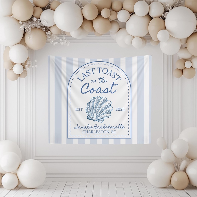 Blue and white striped welcome sign backdrop in a "Last Toast On The Coast" theme. Perfect for a coastal bachelorette party or bridal shower. The welcome sign is surrounded by beige and white balloons arranged in clusters for festive green ogre themed decorations or photo backdrop.