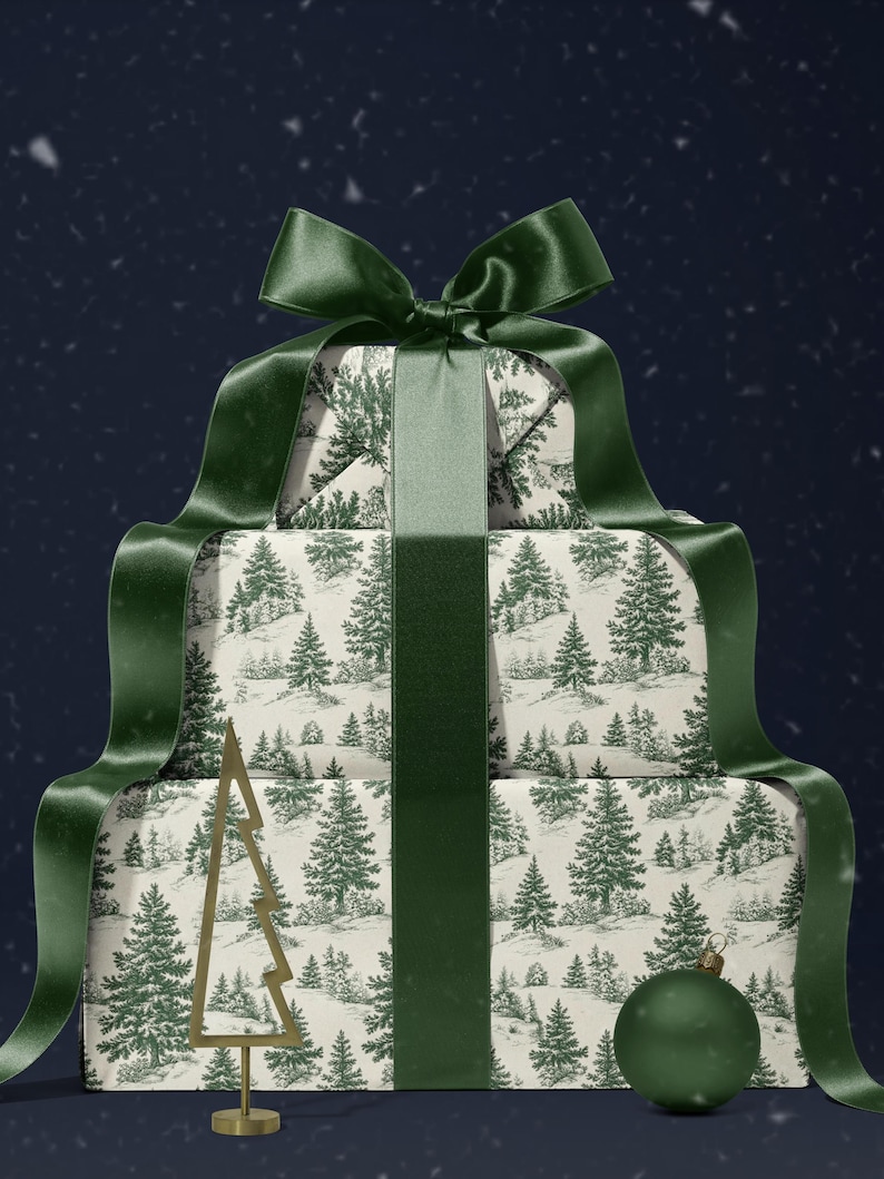 May include: A stack of wrapped gifts with a forest scene pattern, tied with a dark green satin ribbon and bow. A gold-colored metal Christmas tree and a green ornament are placed in front of the gifts.