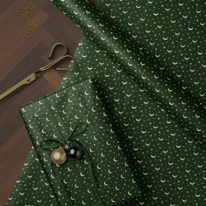 Moon and star Christmas wrapping paper in dark green luxury style