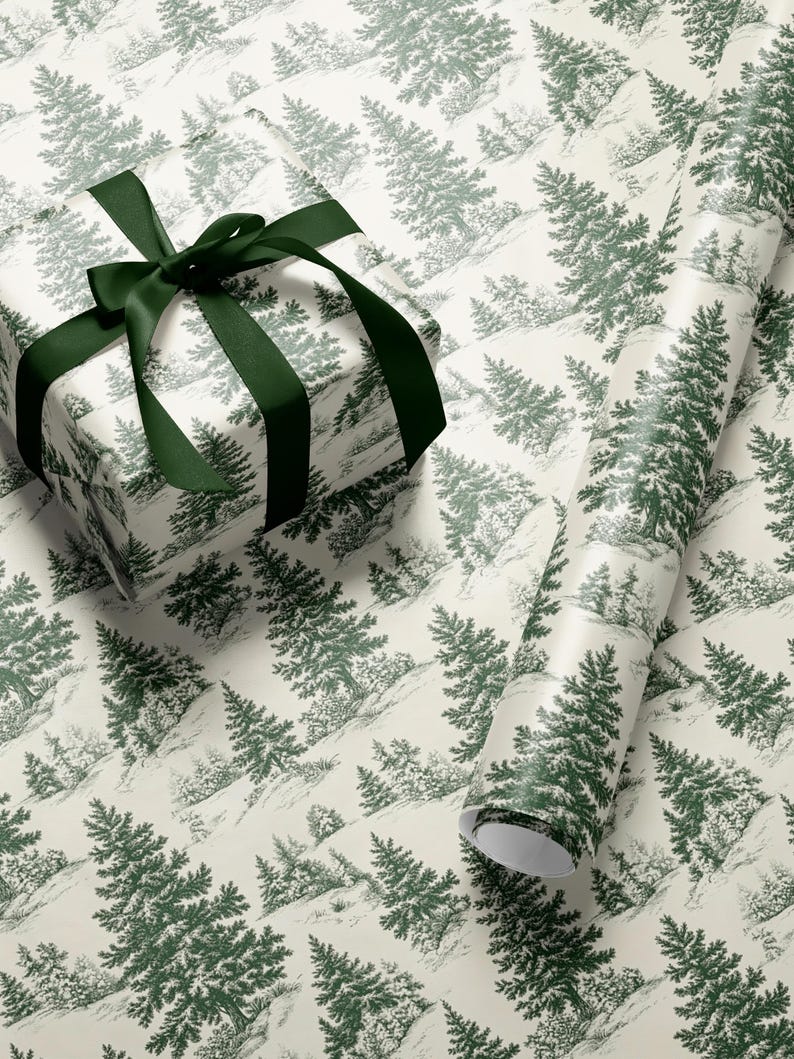 May include: A wrapped gift box and a roll of wrapping paper featuring a green and white forest scene. The gift box is tied with a dark green satin ribbon. The wrapping paper has a repeating pattern of evergreen trees.