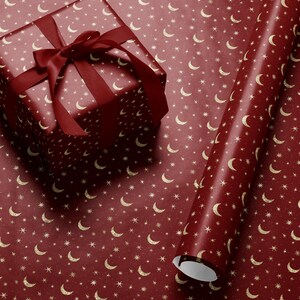 Celestial-themed wrapping paper with gold stars and moon pattern