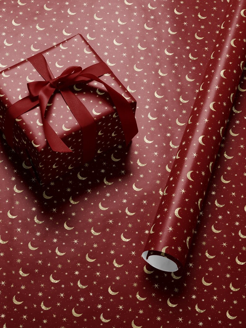 Celestial-themed wrapping paper with gold stars and moon pattern