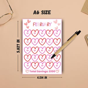 May include: A6 size savings tracker for February, featuring a grid of heart shapes with dollar amounts. The tracker is 5.827 inches tall and 4.134 inches wide, with a total savings goal of $100. The word "FEBRUARY" is at the top.