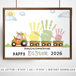 May include: A framed Easter-themed print featuring a bunny driving an orange tractor pulling train cars. Handprints in yellow, green, and pink are above the train. Text reads "Bunny Crew Coming Through!" and "HAPPY Easter 2026."