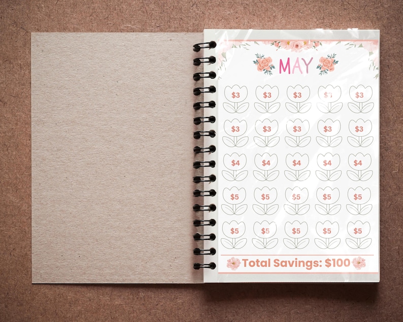 May include: A spiral-bound notebook open to a savings tracker page for May. The page features a floral design with tulip-shaped boxes, each with a dollar amount. The total savings goal is $100.